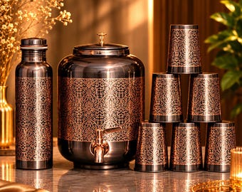 May include: A dark metallic water dispenser with a spigot, a matching bottle, and six tumblers. Each piece features a copper-coloured intricate floral pattern against a dark background. The dispenser has a lid with a small knob on top.