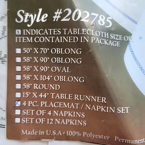 May include: A product label with the text "Style #202785" and a list of tablecloth sizes, including 50" x 70" oblong, 58" x 90" oblong, and 58" x 90" oval. The label also indicates a 4-piece placemat/napkin set.