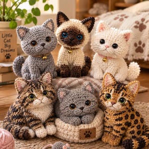 May include: A collection of six crocheted cat plushies in various colors including gray, cream, brown tabby, and spotted patterns. Each cat features large plastic eyes, a small bell collar, and textured yarn. One gray cat rests in a small crocheted bed.