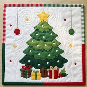 May include: A square quilted wall hanging featuring a central green Christmas tree with a yellow star topper, white polka dots, and three wrapped gifts at the base. The white background has stitched swirls, hanging ornaments, and a red and green gingham border.