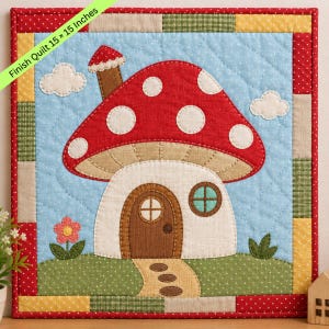 May include: A square quilted wall hanging measuring 38.1 x 38.1 cm featuring a central mushroom house applique. The design includes a red cap with white spots, a brown door, a small window, a chimney, and a path on a light blue background.