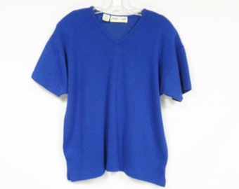 May include: A royal blue short-sleeved v-neck sweater.