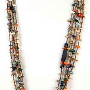 May include: Multi-strand necklace with brown, turquoise, coral, and other colorful stones. The necklace is made of multiple strands of beads and is approximately 20 inches long.