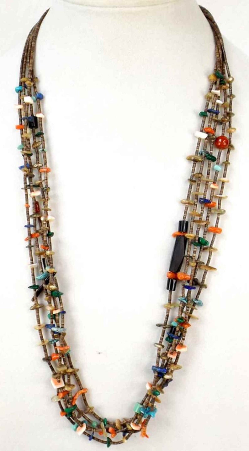 May include: Multi-strand necklace with brown, turquoise, coral, and other colorful stones. The necklace is made of multiple strands of beads and is approximately 20 inches long.