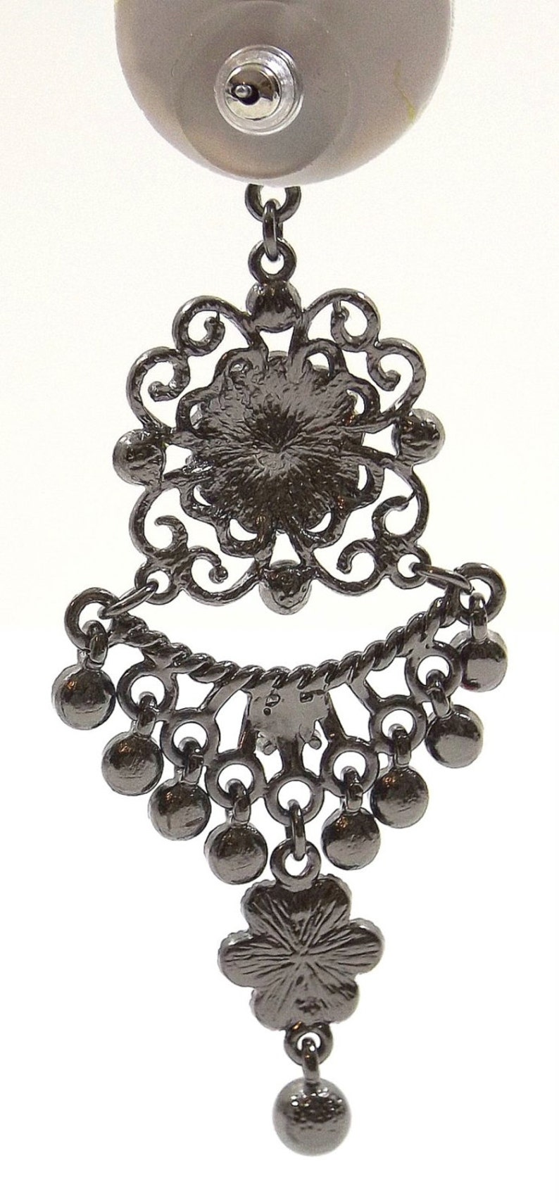 May include: Black filigree dangle earrings with a round black stone in the center and a black bead at the bottom.