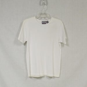 May include: White short-sleeved t-shirt with a Premier label.