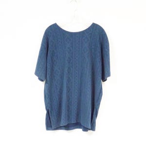 May include: A navy blue short-sleeved shirt with a geometric pattern.