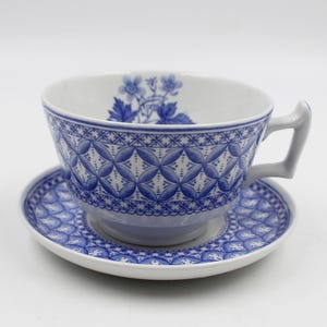 May include: A blue and white porcelain teacup and saucer set with a floral design. The cup and saucer have a delicate blue and white pattern.