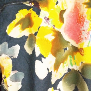May include: Black leggings with a floral print featuring yellow, pink, and green watercolor-style flowers.