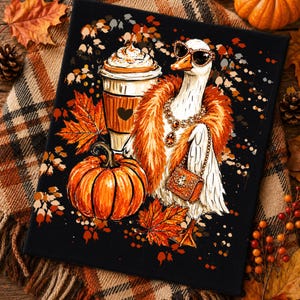 May include: A square canvas print featuring a white goose wearing oversized sunglasses, a fluffy orange feather boa, a jeweled necklace, and a small handbag. Beside the goose is a pumpkin and a coffee cup with a heart icon, surrounded by orange maple leaves on a black background.