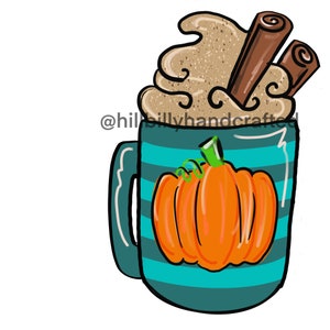 May include: A teal mug with horizontal stripes and a large orange pumpkin illustration. The mug is topped with whipped cream and two cinnamon sticks. The text "@hillbillyhandcrafted" is on the left side of the mug.
