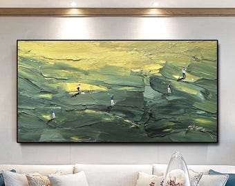 May include: Textured oil painting of a golf course scene. The artwork features a palette of greens and yellows, with miniature figures of golfers in action. The painting is framed in black and hangs above a white sofa.