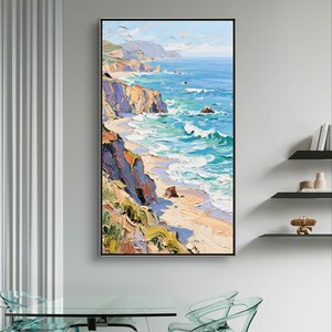 Puede incluir: Una pintura al &oacute;leo de un paisaje costero. La obra representa una escena vibrante del oc&eacute;ano encontr&aacute;ndose con la costa, con acantilados y olas en tonos de azul, verde, amarillo y morado. La pintura est&aacute; enmarcada en un marco negro.