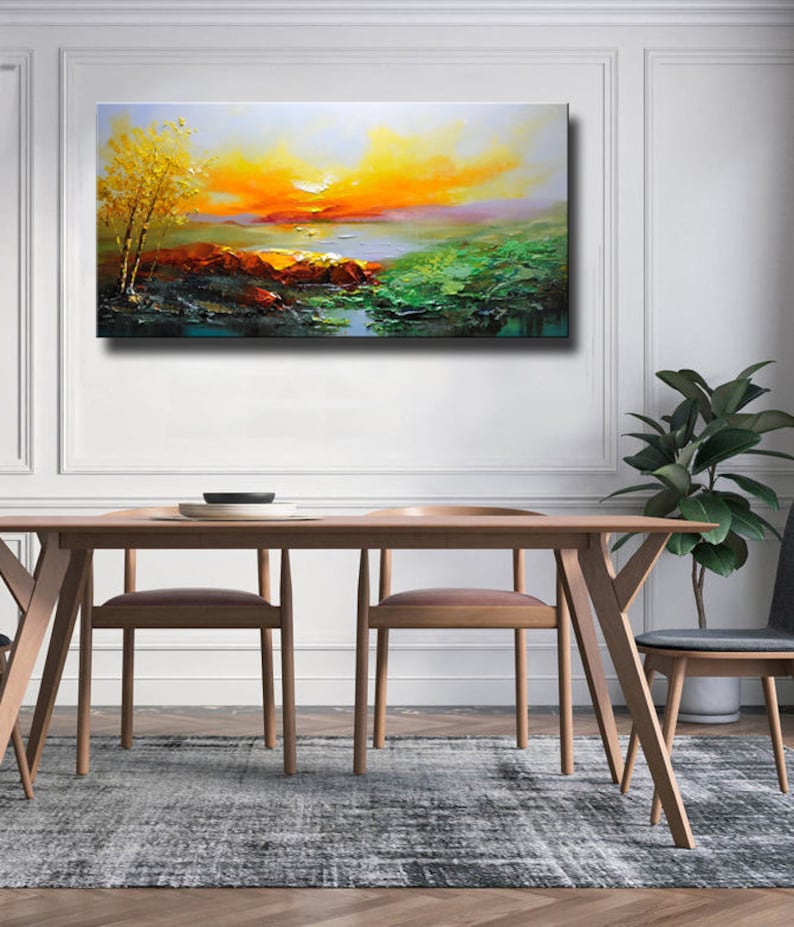 K&ouml;nnte beinhalten: Ein Gem&auml;lde, das einen Sonnenuntergang &uuml;ber einem See mit einem kleinen Baum im Vordergrund zeigt. Der Himmel ist eine Mischung aus Orange, Gelb und Rosa, und das Wasser ist tiefblau. Das Gem&auml;lde ist in einem realistischen Stil ausgef&uuml;hrt.