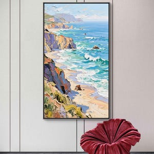 Puede incluir: Pintura al &oacute;leo de un paisaje costero. La obra representa una playa con olas turquesas rompiendo en la orilla. Acantilados con tonos morados, naranjas y verdes bordean la playa. La pintura est&aacute; enmarcada en negro y cuelga de una pared blanca.