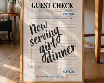 May include: A white sign with black text that reads "GUEST CHECK" and "Now serving girl dinner". The sign is framed in wood and has a grid pattern with numbers on it.