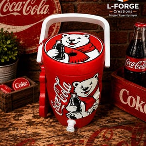May include: A red cylindrical beverage cooler featuring a white handle and a white spigot at the base. The cooler displays a graphic of a white polar bear wearing a red scarf and holding a glass Coca-Cola bottle on both the lid and the front side.