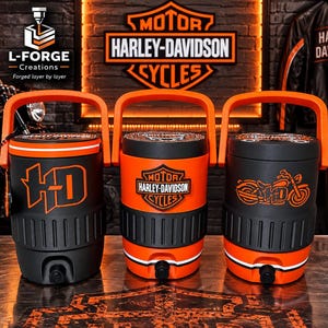 May include: Three cylindrical beverage coolers with orange handles and spigots. The left cooler features orange HD lettering, the centre displays the Harley-Davidson Motor Cycles shield logo, and the right shows an orange motorcycle graphic.
