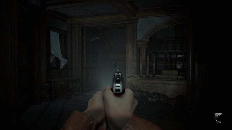 May include: A first-person perspective of a silver handgun held in both hands, aimed forward into a dimly lit, ornate room with dark wooden paneling, a white curtain in a window, and a small ammunition counter displaying 9/0 in the corner.