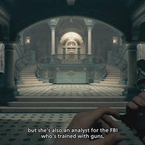 May include: A first-person perspective of a dark handgun held in a hand, set against a grand interior hall with a symmetrical staircase, marble flooring, and columns. Subtitles at the bottom read: but she's also an analyst for the FBI who's trained with guns,
