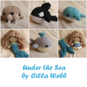 May include: A collection of knitted sea creatures, including a walrus, orca, narwhal, whale, and mermaid. The knitted toys are all in various shades of blue, grey, and white. The title "Under the Sea by Cilla Webb" is written in blue letters on a white background.