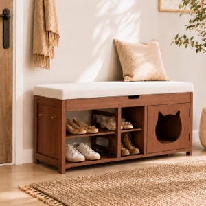 May include: A rectangular wooden shoe storage bench with a cream-colored upholstered seat cushion. The unit features open shelving for footwear and a side cabinet with a cat-shaped cutout opening. The wood has a medium brown finish.
