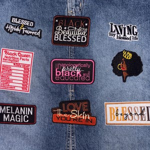 May include: A blue denim fabric background featuring nine embroidered patches with various phrases including Blessed Highly Favored, Black Beautiful Blessed, Living my blessed life, Black Queen Nutrition Facts, Unapologetically pretty black and educated, Melanin Magic, Love the skin you're in, and Blessed beyond, plus a patch of a person with an afro and crown.