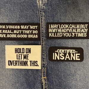 May include: Four rectangular embroidered patches with white text on black or white backgrounds. The patches read: THE VOICES MAY NOT BE REAL, BUT THEY DO HAVE SOME GOOD IDEAS, I MAY LOOK CALM BUT IN MY HEAD I'VE ALREADY KILLED YOU 3 TIMES, HOLD ON LET ME OVERTHINK THIS, and CERTIFIED INSANE.