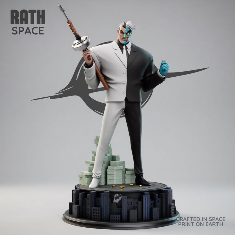 May include: A Two-Face statue, split down the middle with a white and black suit, holding a Tommy gun. The statue stands on a base with a cityscape and stacks of money. The text "RATH SPACE" is at the top left.