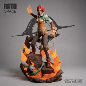 May include: A collectible figurine of a red-haired character in a yellow tunic and brown pants, standing on a rocky base surrounded by translucent orange flames. The figure holds fire in both hands. Text reads RATH SPACE and CRAFTED IN SPACE PRINT ON EARTH.