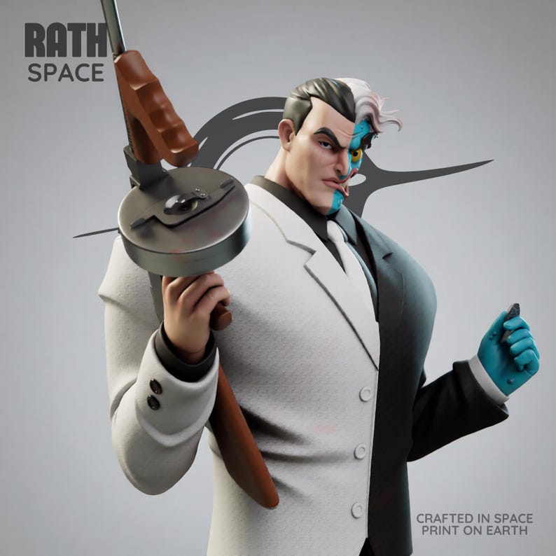 May include: A detailed statue of the DC Comics villain Two-Face, split down the middle with one side in a white suit and the other in a black suit. He holds a Tommy gun and a small object. The text "RATH SPACE" is visible.