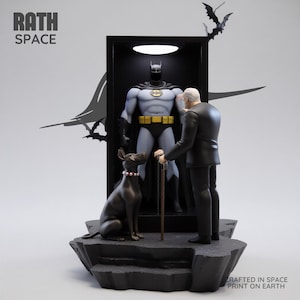 May include: A Batman figurine stands in a display case, with a figure of Alfred Pennyworth and a black dog. The figurine is on a black, rocky base, with bat silhouettes and the text "RATH SPACE" and "CRAFTED IN SPACE PRINT ON EARTH".