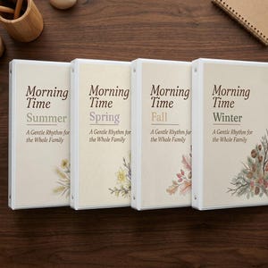 May include: Four white three-ring binders with cream-colored covers, each labeled Morning Time followed by the season name Summer, Spring, Fall, or Winter, and the subtitle A Gentle Rhythm for the Whole Family, featuring seasonal floral illustrations.
