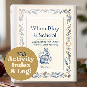 May include: A white three-ring binder featuring a cover with the text "When Play is School: Documenting Your Child's Interest-Driven Learning by Allison Payne" and a gold circular overlay stating "With Activity Index & Log!" with a rabbit illustration.
