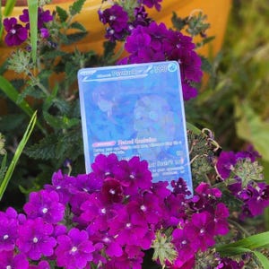 May include: A holographic Pokemon card featuring Psyduck with the text "Mutual Confusion" and "Our Soul's Up" on the card.