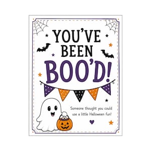 May include: A rectangular Halloween sign with a white background, featuring the text YOU'VE BEEN BOO'D! in black and purple. It includes a white ghost holding an orange jack-o'-lantern, black bats, spiderwebs, and a colourful bunting banner.