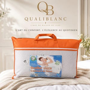 May include: A rectangular white memory foam pillow encased in a clear plastic bag with orange fabric trim and handles. The packaging features a label with the text Oreiller visco &agrave; m&eacute;moire de forme, an illustration of a person sleeping, and dimensions of 40 x 60 cm.
