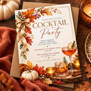 May include: A rectangular cocktail party invitation card featuring a gold ribbon, autumn leaves, and berries. The text reads: PLEASE JOIN US FOR A COCKTAIL PARTY, GOOD DRINKS GREAT COMPANY ALL THE FALL VIBES, SATURDAY, OCTOBER 18TH 6:00 PM, THE HARRISON HOME 123 MAPLE LANE, KINDLY RSVP BY OCTOBER 10TH.