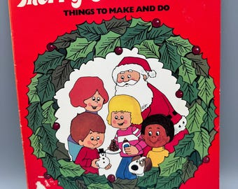 May include: A red softcover book titled Merry Christmas! THINGS TO MAKE AND DO. The cover features a large green holly wreath surrounding an illustration of Santa Claus, four children, and a small dog, all depicted in a cartoon style.