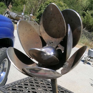 metal yard art flower made from spoons recycled
