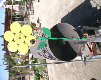 Hand made sunflower out of recycled material approx. 10x10 x24" tall  with ladybug