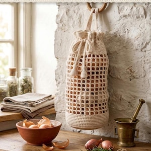 May include: A cream-colored crochet onion garlic bag featuring a grid-patterned body, a solid base, and a drawstring closure with tassels. The bag hangs from a wooden ring and contains several onions. Text reads: CROCHET ONION GARLIC BAG INSTANT DOWNLOAD HIGH QUALITY.