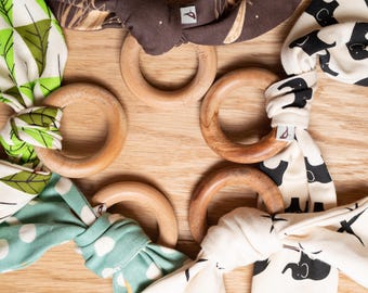 Organic cotton bunny ear teether featuring a natural, untreated maple wood ring.