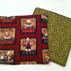 May include: Two red and green fabric pot holders with a chef theme. The red pot holder has a variety of images of chefs with the words "Pasta", "Save the Flavor Delectable", "Veggies", "Fresh Catch Seafood", and "Little Coffee Bar". The green pot holder has a pattern of green circles on a white background.