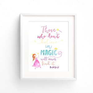May include: A white framed print with a watercolor illustration of a princess holding a wand. The quote "Those who don't believe in magic will never find it" is written in colorful script with the author "Roald Dahl" at the bottom.