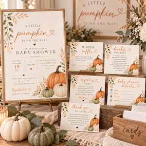 May include: A set of baby shower stationery featuring a large invitation, diaper raffle card, books for baby card, registry card, baby shower details card, and thank you card, all decorated with orange and green pumpkin illustrations and foliage.