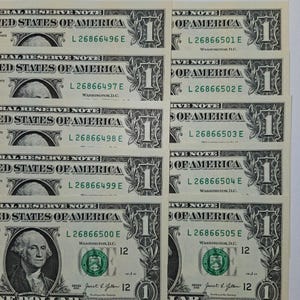 May include: A collection of ten sequential United States one-dollar bills arranged in two columns. Each note features the portrait of George Washington, the text Federal Reserve Note, and unique serial numbers ranging from L 26866496 E to L 26866505 E.