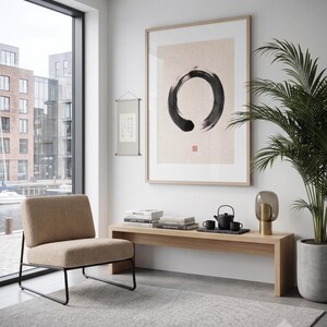 Framed Sumi Enso print displayed above a modern console table in a Japandi-inspired living room with neutral decor.