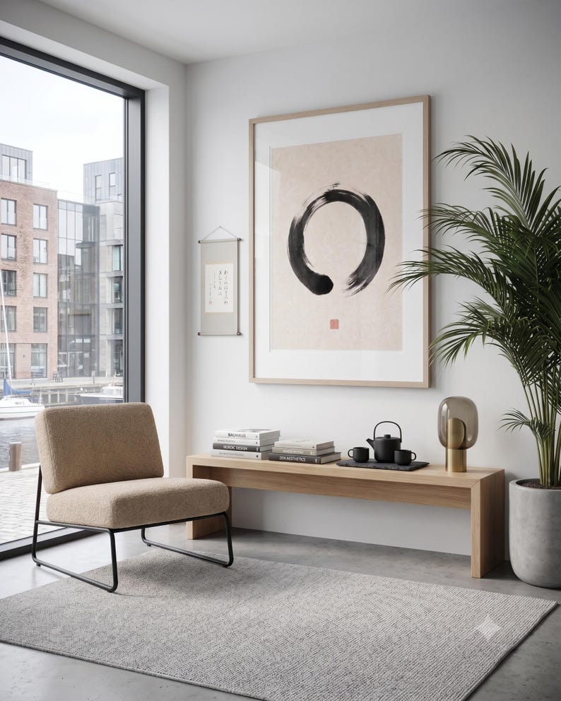 Framed Sumi Enso print displayed above a modern console table in a Japandi-inspired living room with neutral decor.