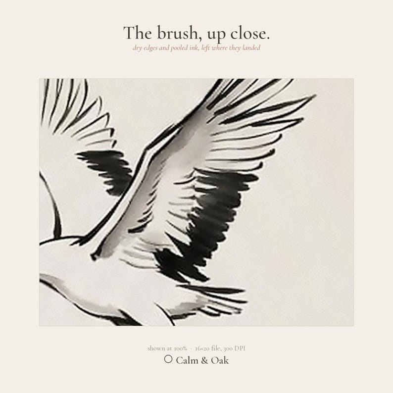 Sumi-e crane print framed in oak, seen on three quiet walls — above a linen bed, on a gallery wall and above an oak console.